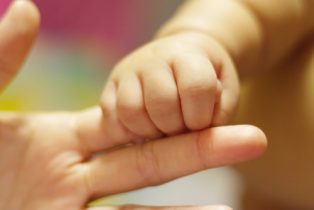 Baby,Holding,Finger,Of,His,Mother,Giving,Senses,Of,Attachment